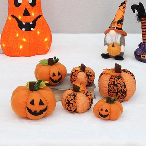 Detail of fabric Halloween pumpkins with spider web patterns and Jack-o'-lantern faces
