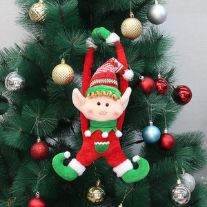 Dettaglio di un elfo di Natale in peluche appeso a un albero di Natale decorato