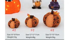 Three sizes of fabric Halloween pumpkins with spider web patterns for party decor