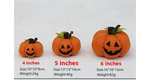 Three sizes of orange plush Halloween pumpkins with black felt faces on white background