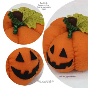 Detail of plush Halloween pumpkin showing simulated leaves, glitter vines and fabric stem