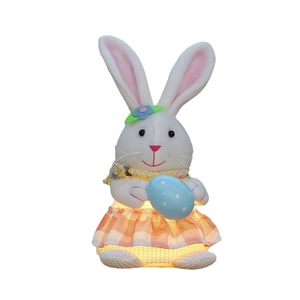 Easter glowing plush bunny with colorful egg and orange plaid skirt on white background