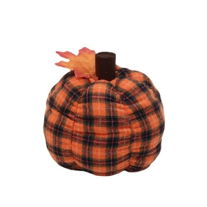 Detail of plaid fabric pumpkin with orange and black checks and fall maple leaf decor