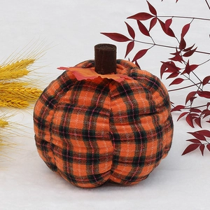 Plaid fabric pumpkin decor with orange and black patterns for autumn harvest festival