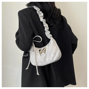 Detail of silver pleated shoulder bag with metallic butterfly buckle and cloud strap