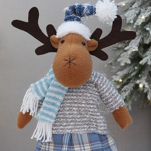 Detailed close-up of a Christmas reindeer plush toy with a blue striped hat and plaid skirt