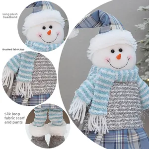 Detail showing blue plaid hat and soft plush fabric textures on a Christmas snowman doll