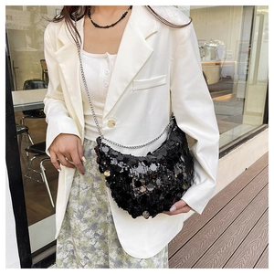 Detailed view of a black sequin crescent bag featuring a stylish silver chain shoulder strap
