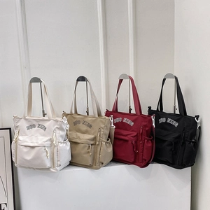 Large capacity nylon tote bags in four colors with shoulder straps for daily travel
