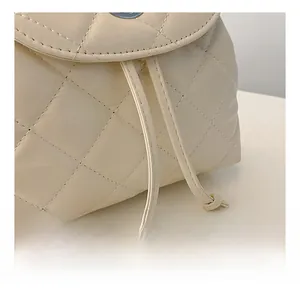 Detail shot of beige quilted leather handbag with durable drawstring and refined stitching
