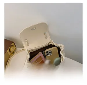 Spacious interior of white quilted chain bag showing phone and cosmetics storage