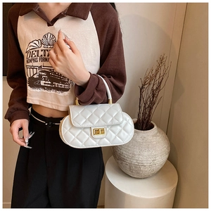 Close-up of white quilted crossbody bag with golden metal lock and top handle detail