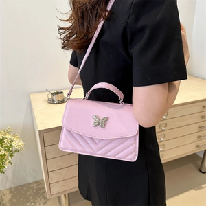 Pink quilted crossbody bag with silver butterfly buckle and adjustable strap for women