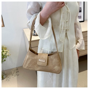 Minimalist khaki suede baguette bag featuring a stylish silver buckle and sleek texture
