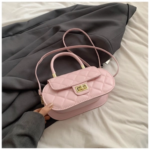 Close-up of pink quilted crossbody bag with gold twist lock and elegant top handle