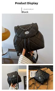 Detail of black quilted leather backpack featuring diamond stitching and metal chain strap
