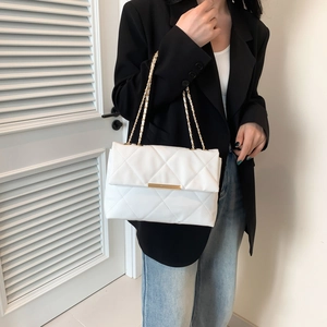 Minimalist white quilted shoulder bag with gold chain strap and metallic flap closure