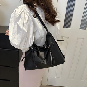 Fashionable black faux leather tote with decorative bows and zippers for women