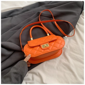 Detailed top view of orange quilted leather crossbody bag with gold turn-lock closure