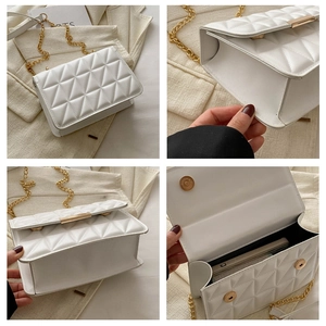 Close-up of white quilted PU leather crossbody bag with gold chain strap and magnetic snap