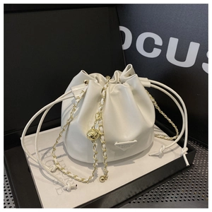 Detail of white PU leather drawstring bucket bag with gold chain strap in a premium gift box