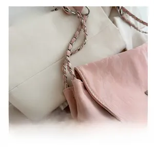 Detail of pink pleated PU leather texture with metal and leather woven chain strap