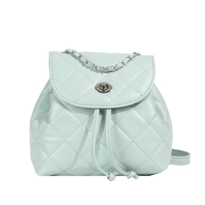 Mint green quilted faux leather backpack with silver chain handle and metal twist lock
