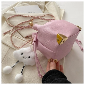 Detail of pink drawstring bucket bag with gold metal corners and plush cloud charm