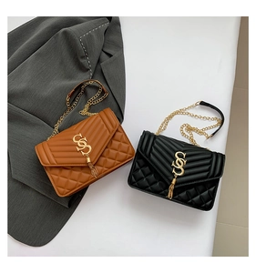 Detail der gesteppten Umhängetaschen mit goldenen Kettenriemen und Fransen-Logos
