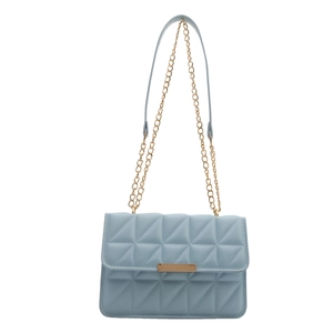 Elegant light blue quilted crossbody bag with gold chain strap and geometric stitching