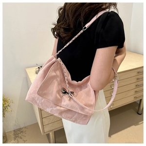 Close-up of pink marble pattern shoulder bag with silver butterfly buckle and chain strap