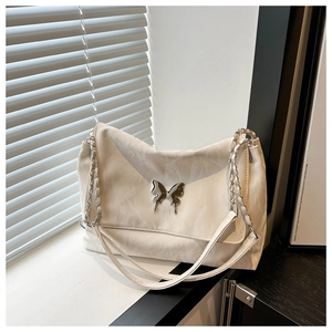 Detailed view of cream PU leather crossbody bag with silver butterfly metal clasp