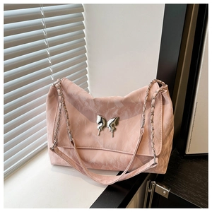 Macro detail of pink marble texture PU leather bag with silver butterfly buckle