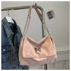 Detail of pink pleated PU shoulder bag with silver butterfly and liquid metal charm