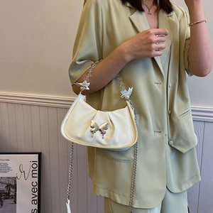 Chic white pleated crescent bag with silver butterfly and pearl chain strap for women