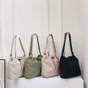 Japanese style large capacity drawstring bucket bag in four neutral colors displayed on white