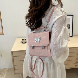 Pink mini backpack for women with butterfly metallic buckle and textured shiny finish