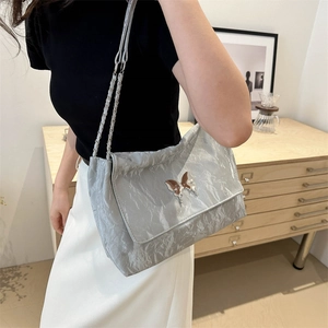 Silver wrinkled PU leather crossbody bag with butterfly buckle and metal chain strap