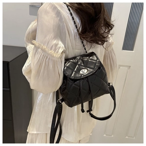 Chic black quilted backpack featuring silver chain straps and a metal twist-lock clasp