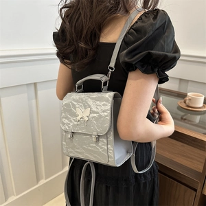Silver mini backpack with crinkled metallic leather and elegant butterfly metal buckle