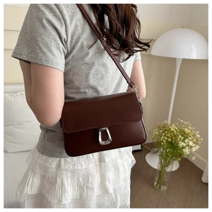 Brown vintage faux leather crossbody bag with silver geometric clasp and slim strap