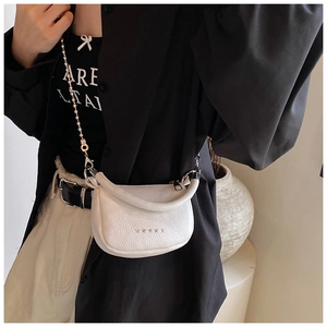 Detail of white mini crescent bag with litchi grain leather and star decoration