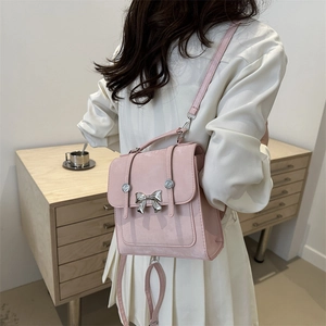 Pink matte vintage backpack with silver butterfly detail and adjustable straps for women