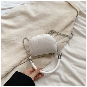 Detail of white lychee-textured crossbody bag with silver bead chain and sturdy handle