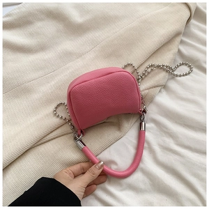 Pink lychee grain leather crossbody bag with silver beaded chain and top handle detail