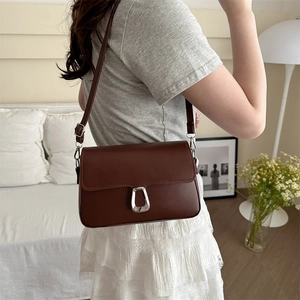 Minimalist dark brown leather crossbody bag with silver trapezoid buckle for women