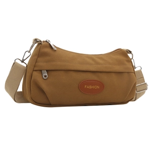Brown canvas shoulder bag with FASHION patch and adjustable straps on white background