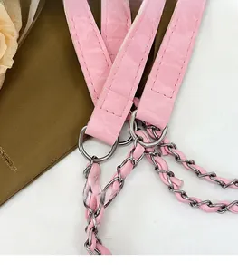 Detail of pink leather and silver metal chain strap with polished connector ring