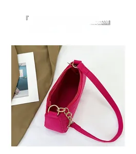 Internal view of magenta felt shoulder bag showing large capacity and zipper pocket