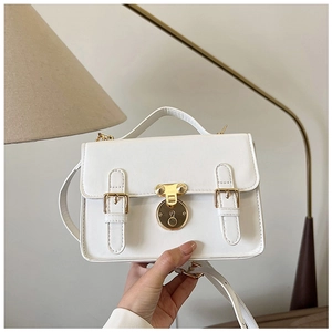 Close-up of a white PU leather square bag featuring golden buckle lock and top handle
